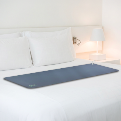 Gaia grounding mat displayed across a bed