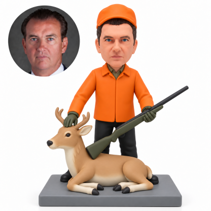 custom bobblehead figure male hunter holding a miniature rifle beside a reclining sculpted deer