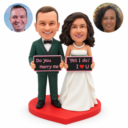 custom bobblehead figures wedding couple each holding a separate rectangular sign with both hands