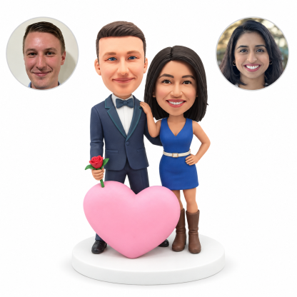 Custom clay romantic couple bobbleheads: man holding one rose beside a large pink heart, woman resting a hand on his shoulder, with matching real photo portraits.