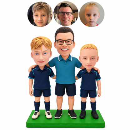 Custom soccer coach bobblehead with two young players standing together on a green base in teal and navy uniforms, with matching portrait photos above.