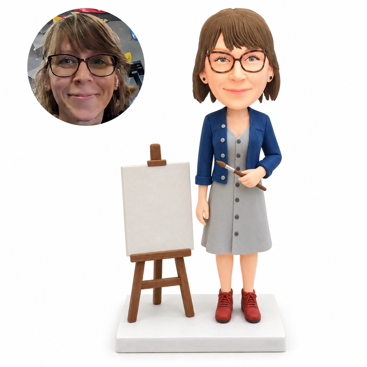 custom bobblehead figure female art teacher in a dress holding a paintbrush beside an easel