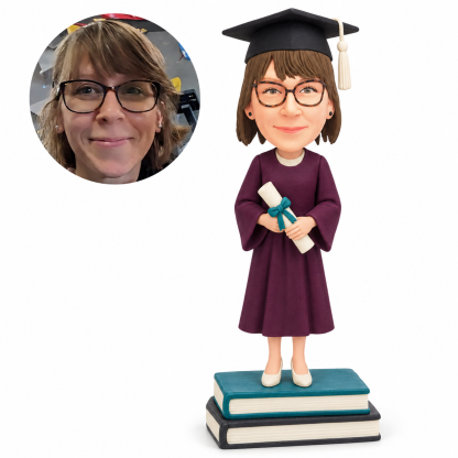 custom bobblehead figure female graduate holding a diploma while standing on stacked books