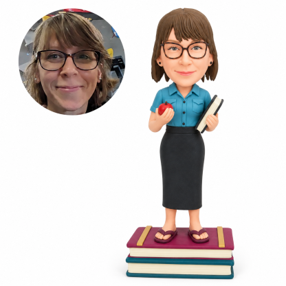 custom bobblehead figure female teacher holding an apple and a book while standing on stacked books