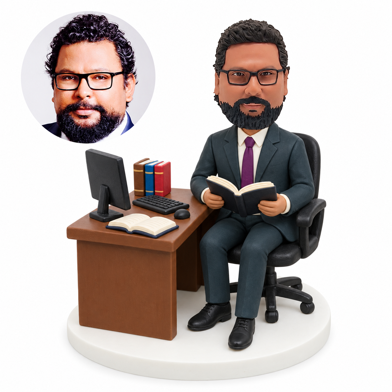 custom bobblehead figure businessman seated at a computer desk holding an open book