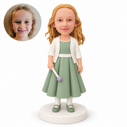 Custom polymer-clay bobblehead girl in a sage green pleated gown holding one lowered round-tipped wand