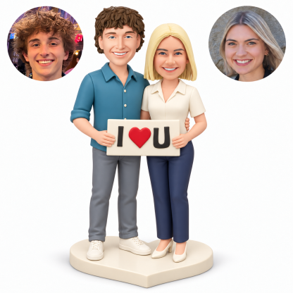 custom bobbleheads figures couple holding one rectangular heart plaque while he embraces her waist
