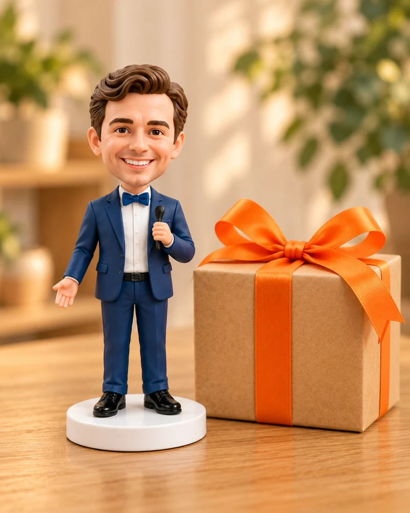 The completed personalised bobblehead beside a gift parcel with an orange bow.