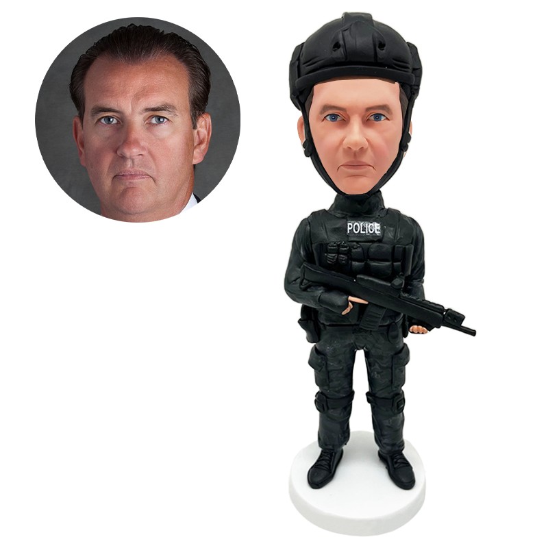 bobble head figurine man holding a gun