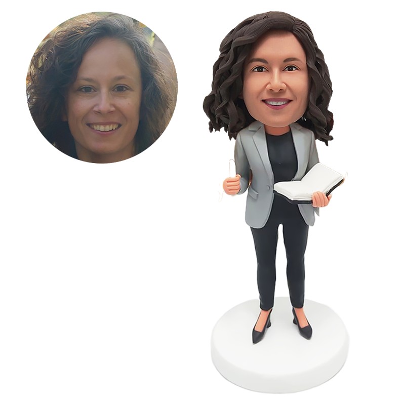 custom made bobblehead teacher holding a notebook