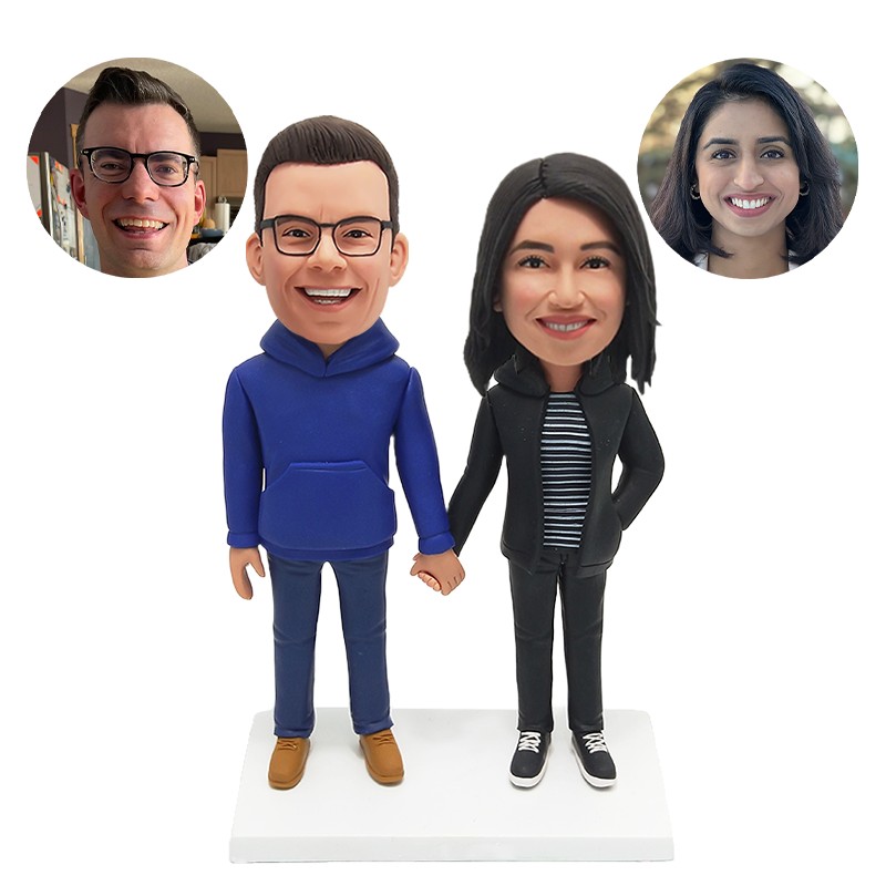 bobble head figurine couple walking hand in hand