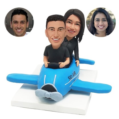 personalized bobblehead couple sitting on a plane