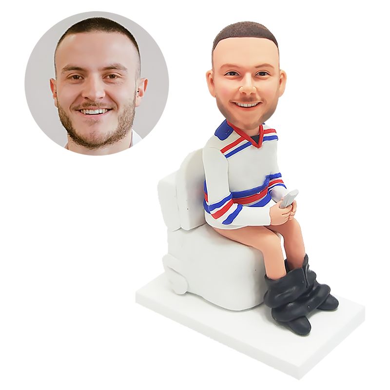 custom made bobblehead man holding a cell phone in toilet