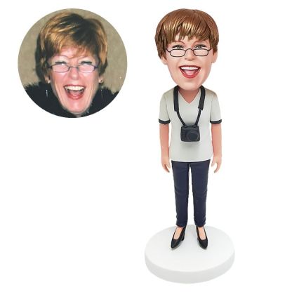 bobble head figurine lady with a camera