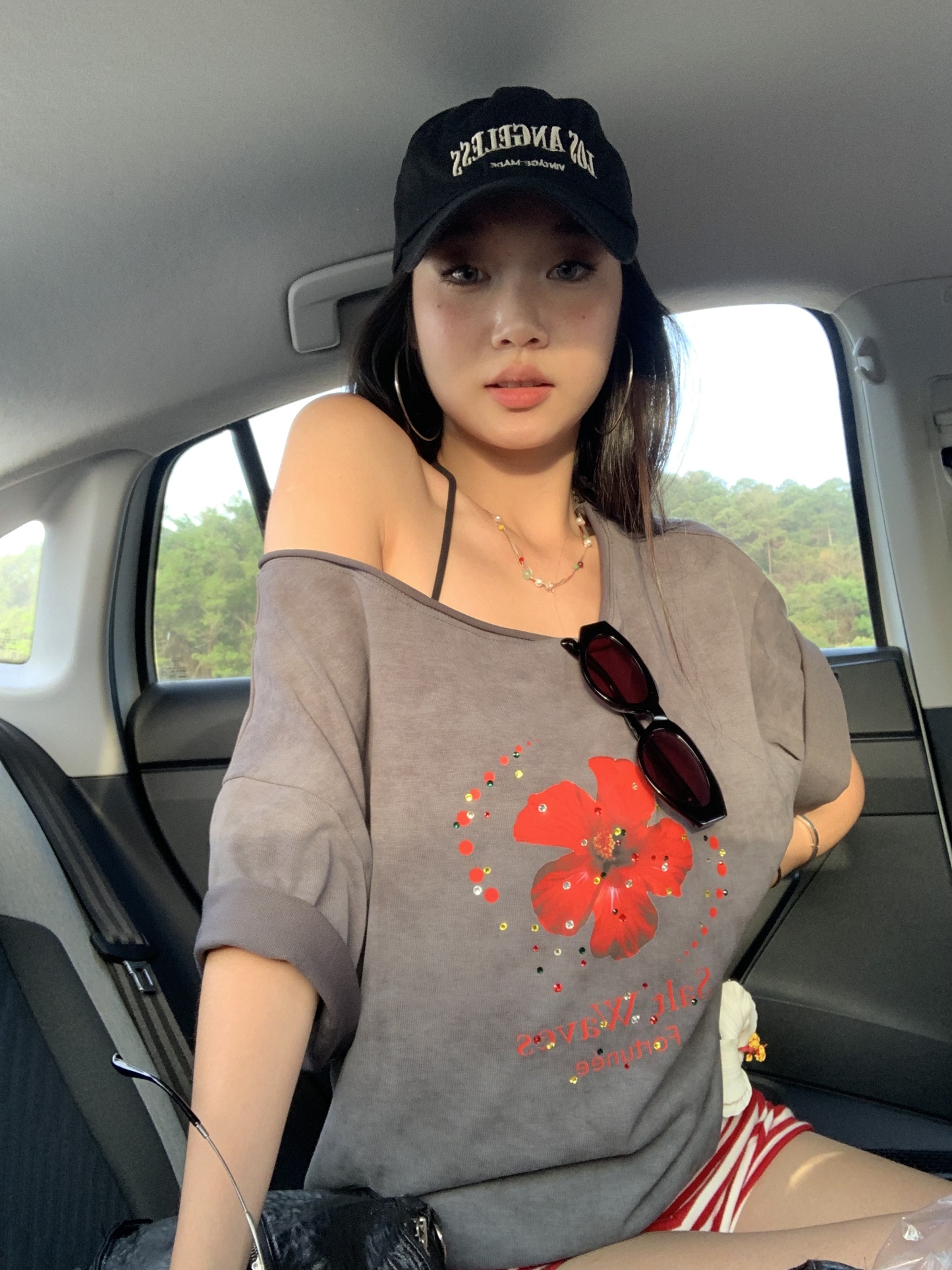 Loose fit hibiscus floral top with one shoulder cutouts