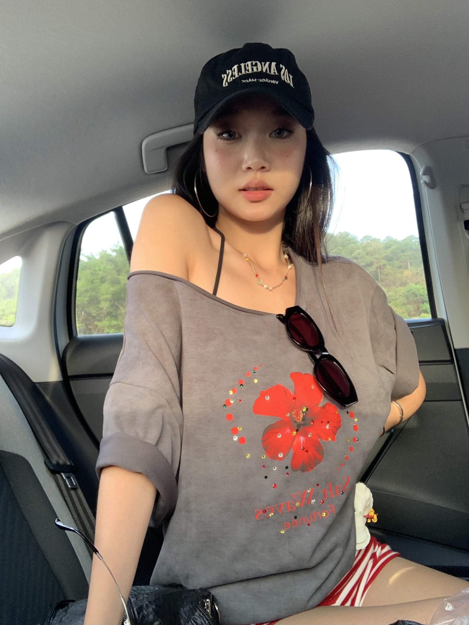 Loose fit hibiscus floral top with one shoulder cutouts