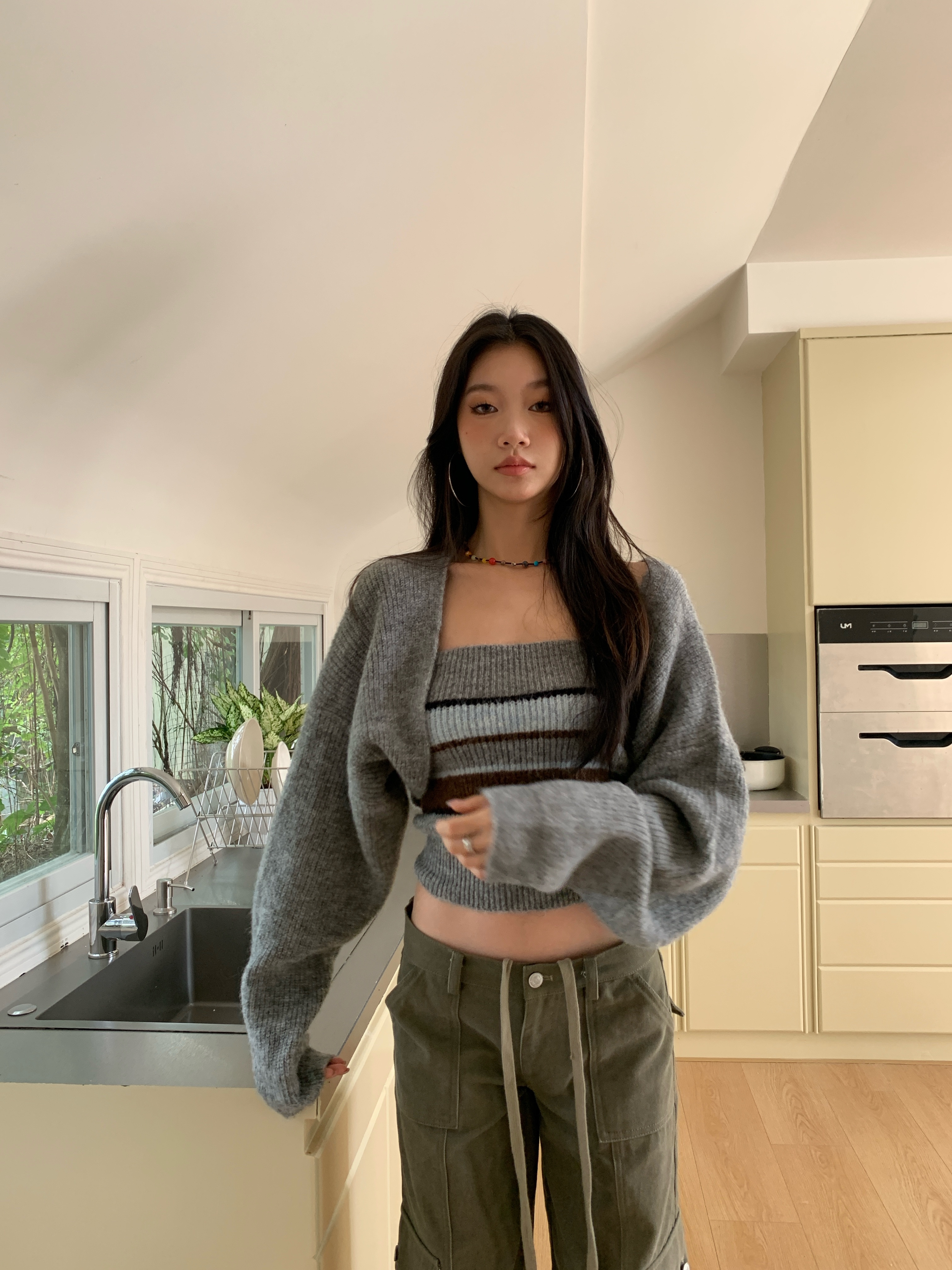 Two-piece set consisting of a two-tone striped knit tube top and a long-sleeve cardigan.