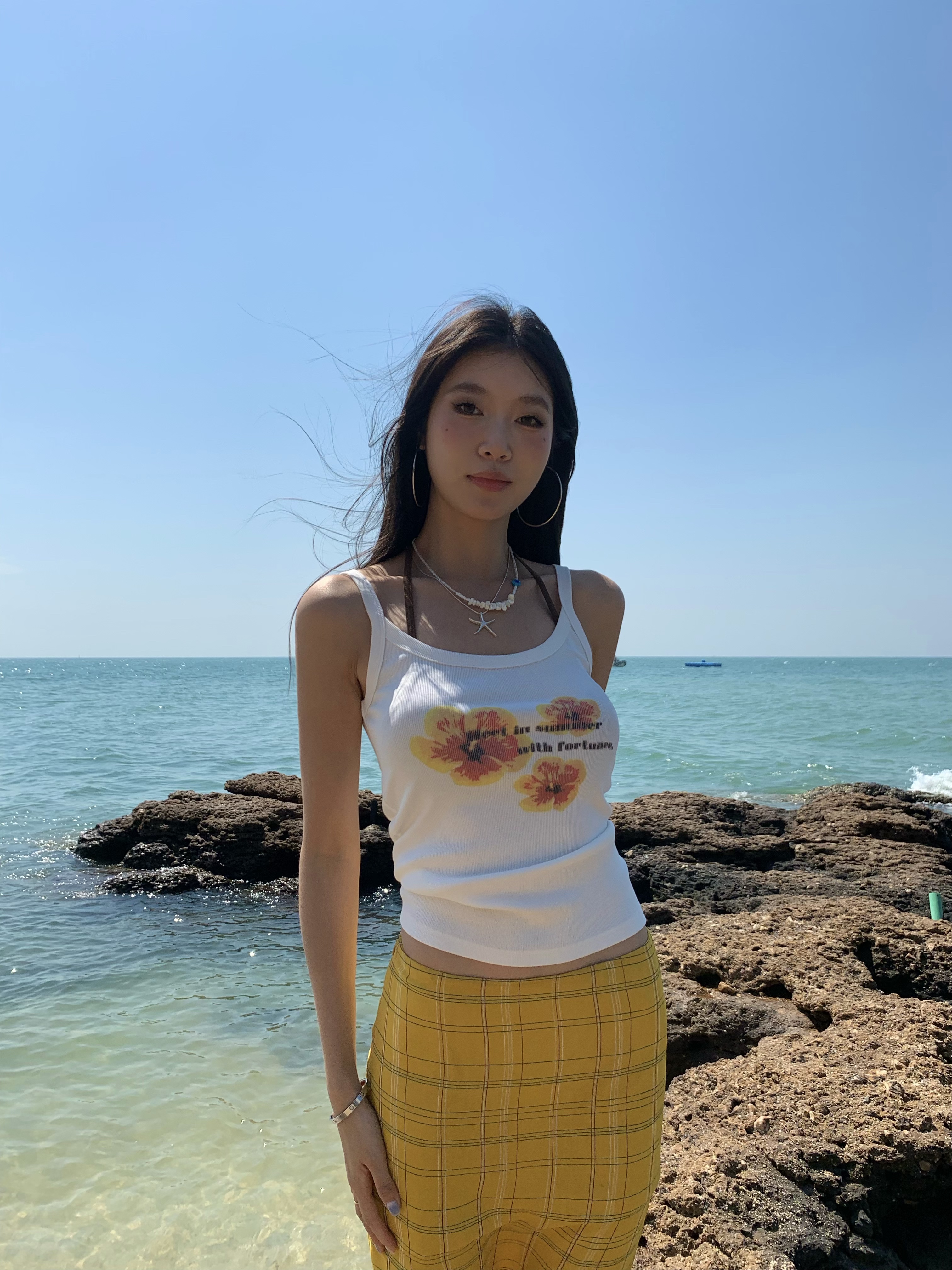 White spaghetti strap top with yellow flowers, bright style, perfect for summer