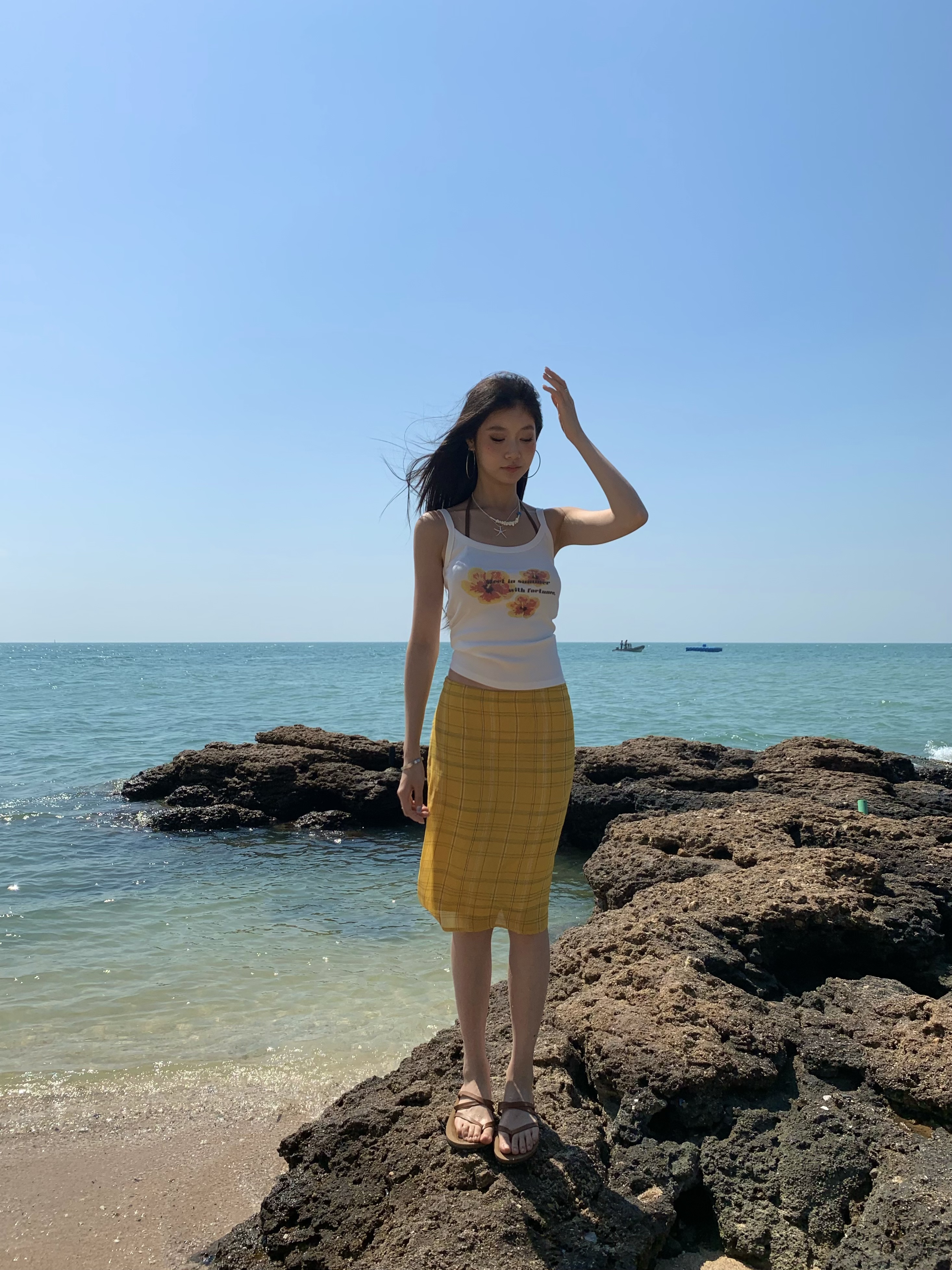 White spaghetti strap top with yellow flowers, bright style, perfect for summer