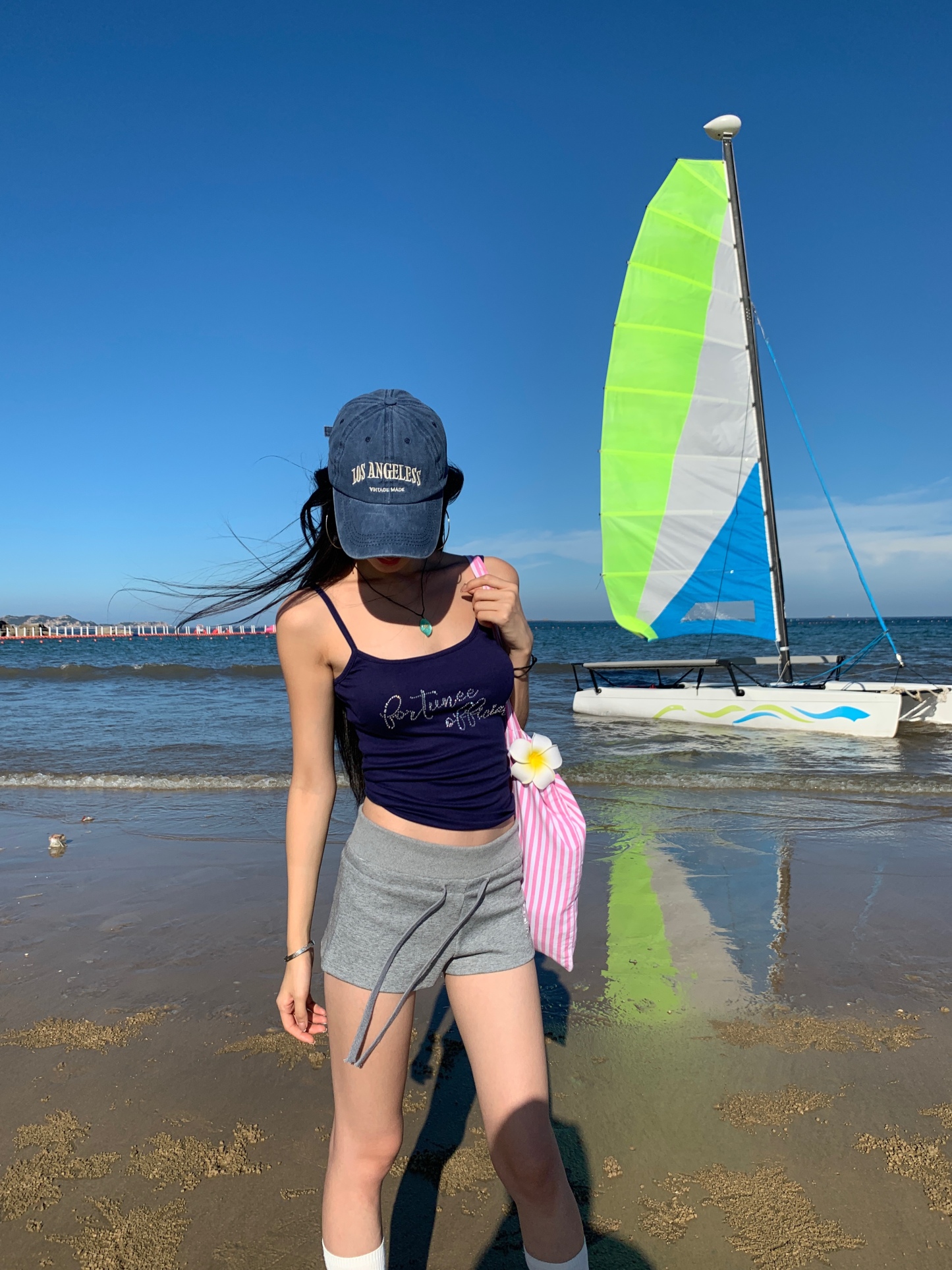 A fitted blue tank top for summer, embellished with a rhinestone letter logo