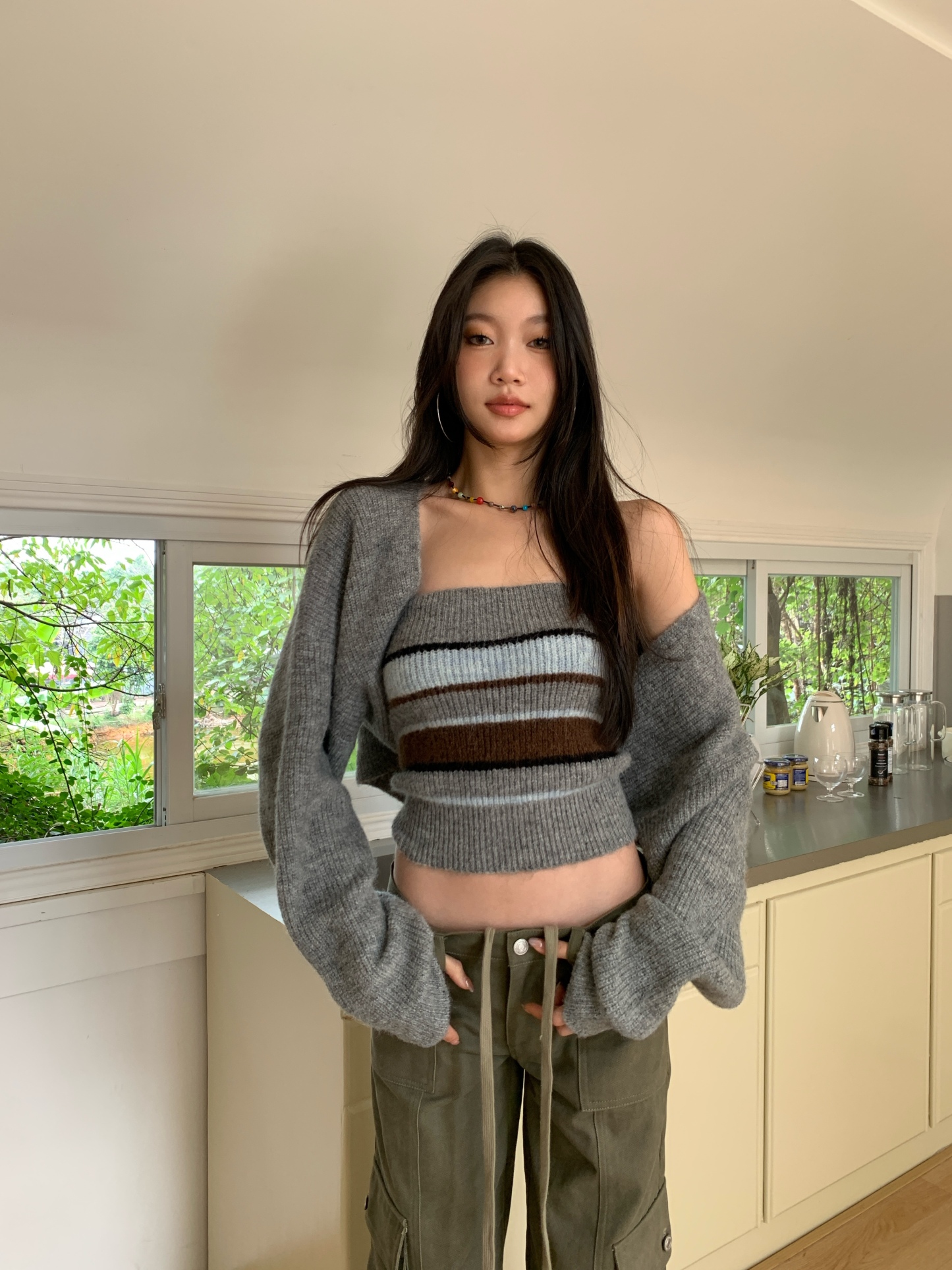 Two-piece set consisting of a two-tone striped knit tube top and a long-sleeve cardigan.