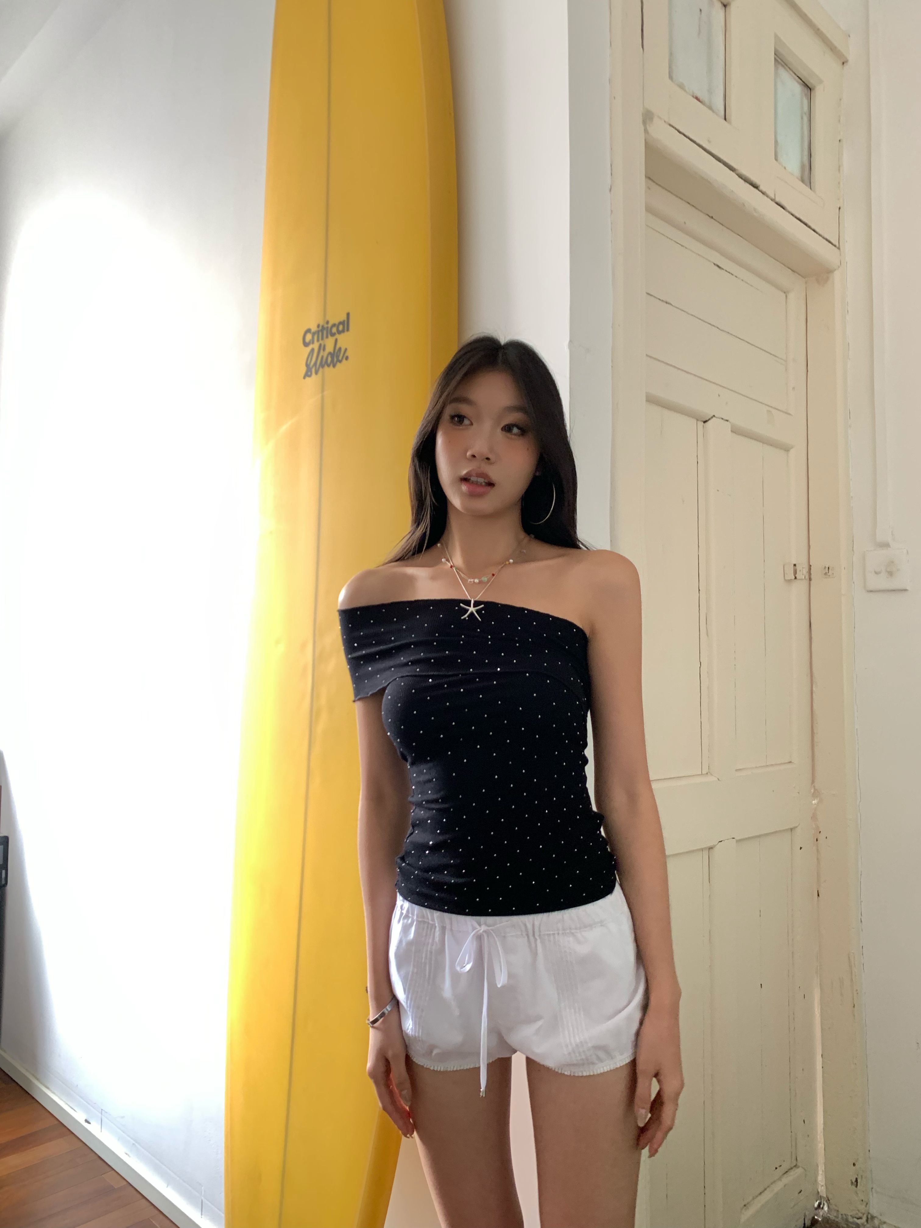 Black one-shoulder crop top with polka dots