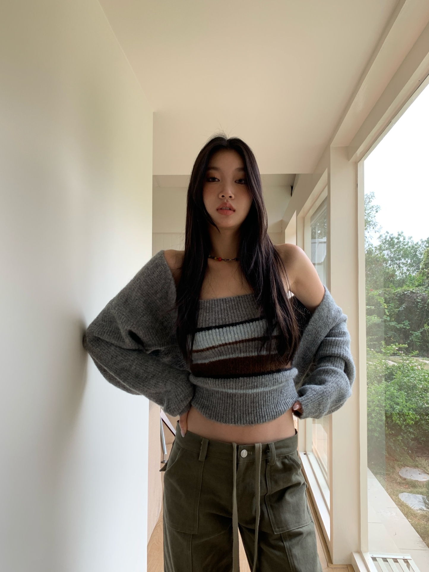 Two-piece set consisting of a two-tone striped knit tube top and a long-sleeve cardigan.