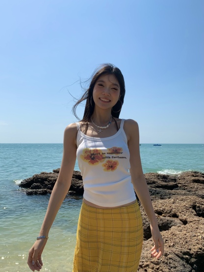 White spaghetti strap top with yellow flowers, bright style, perfect for summer