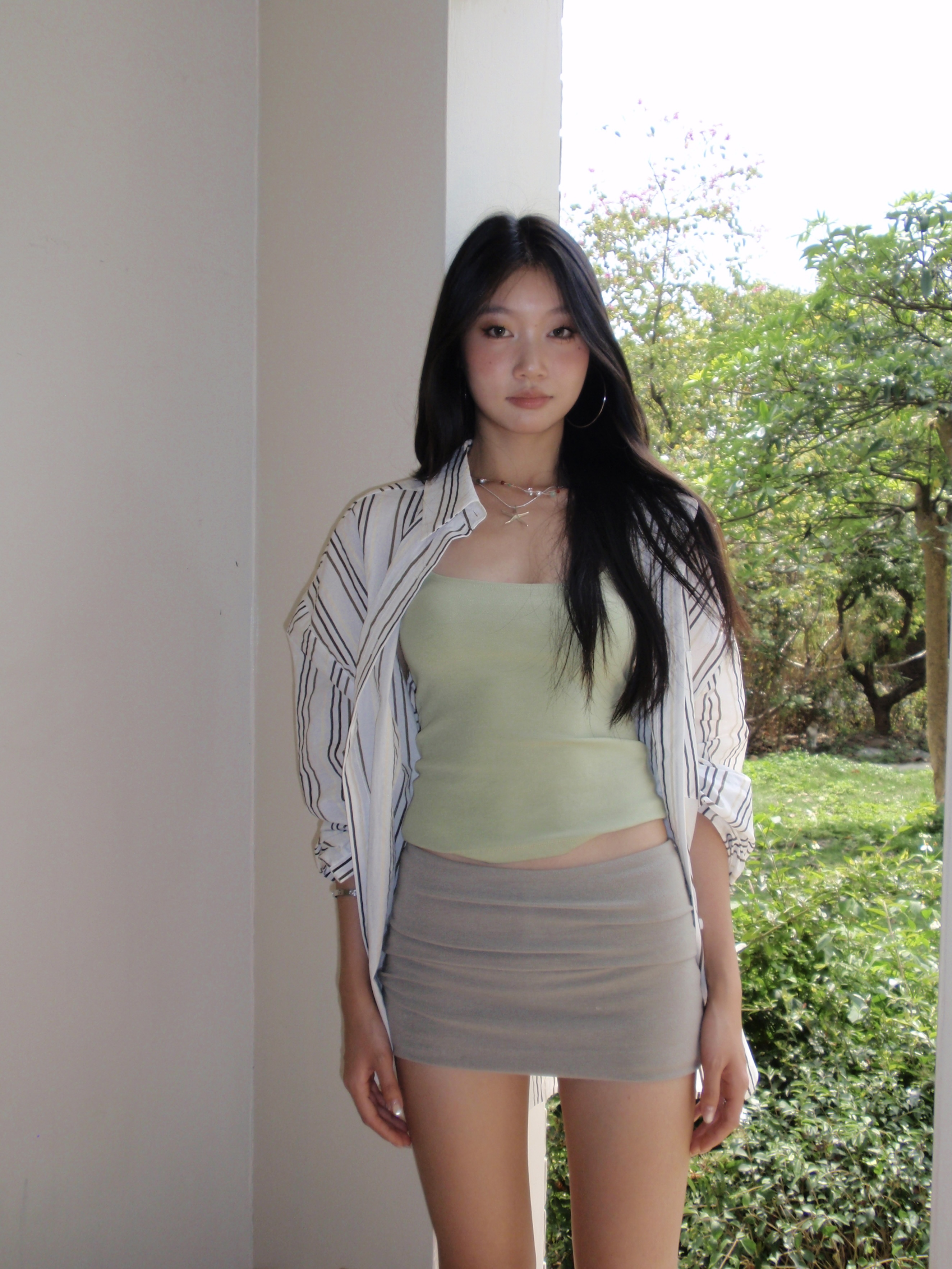 Green spaghetti strap top in a sexy style. Wear it as an inner shirt or wear it alone and it will look good.