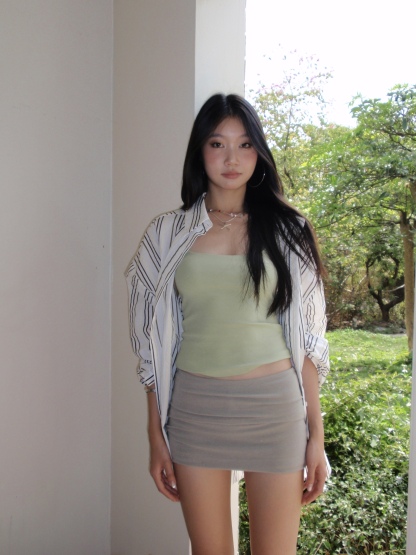 Green spaghetti strap top in a sexy style. Wear it as an inner shirt or wear it alone and it will look good.