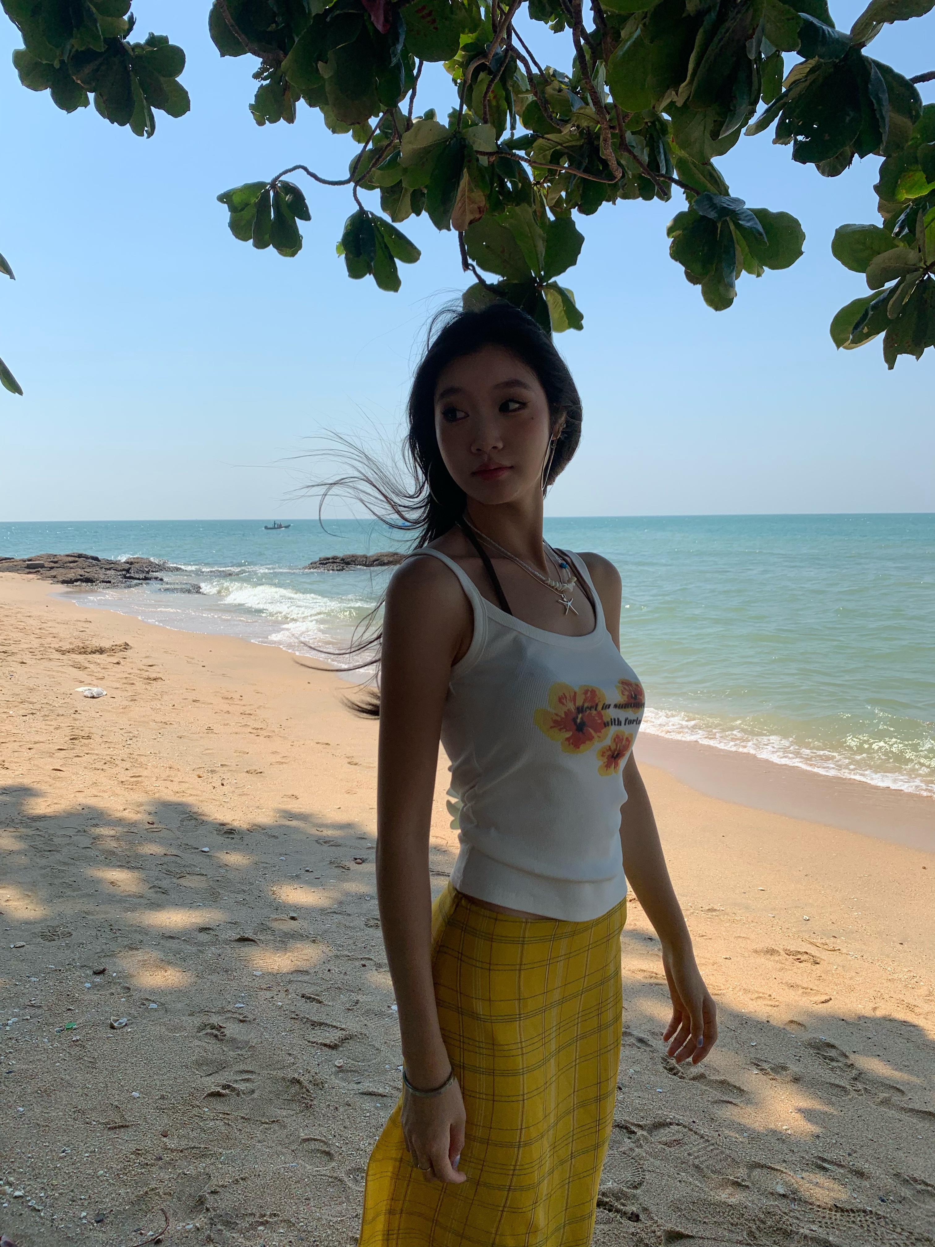 White spaghetti strap top with yellow flowers, bright style, perfect for summer