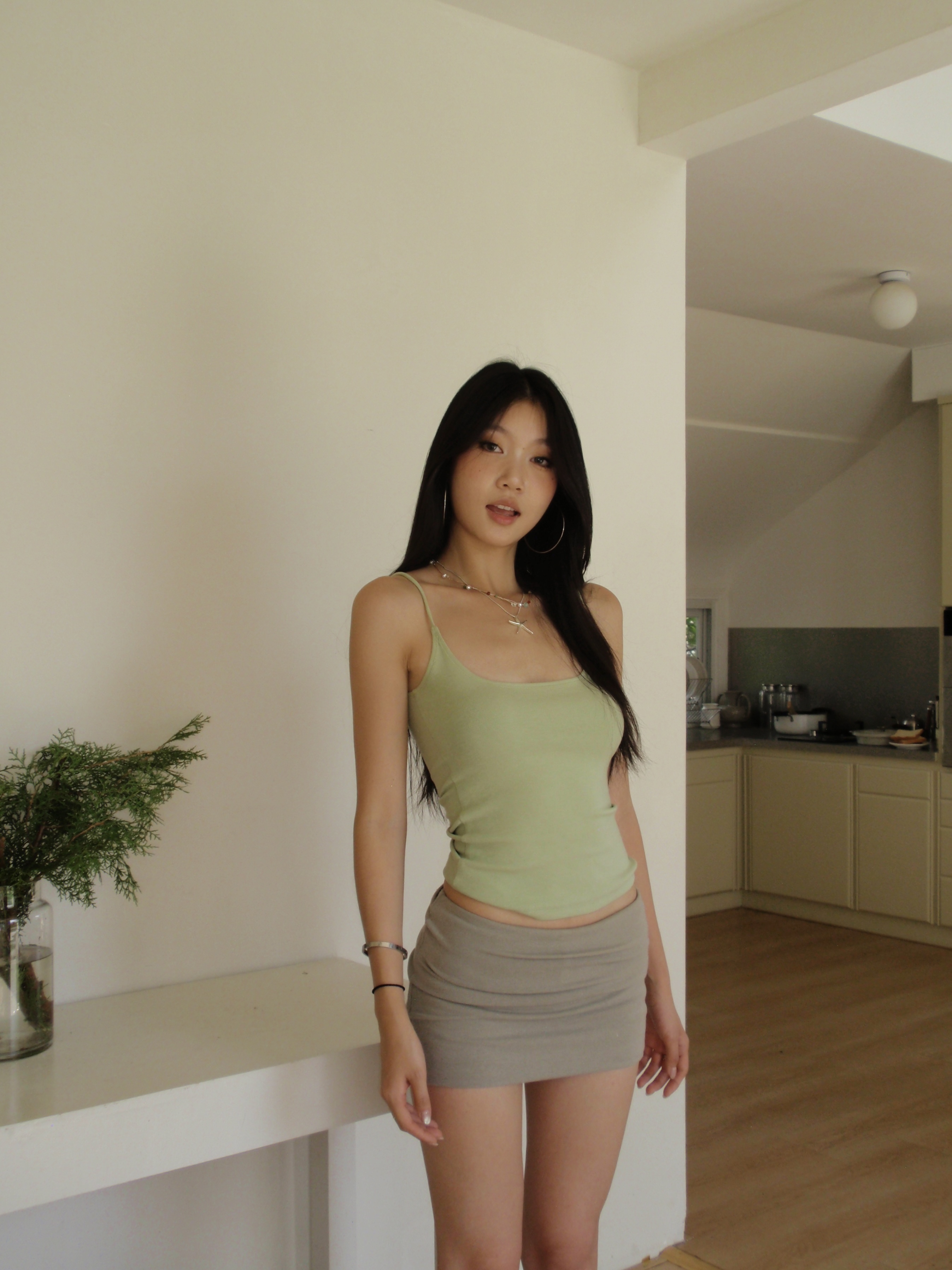 Green spaghetti strap top in a sexy style. Wear it as an inner shirt or wear it alone and it will look good.