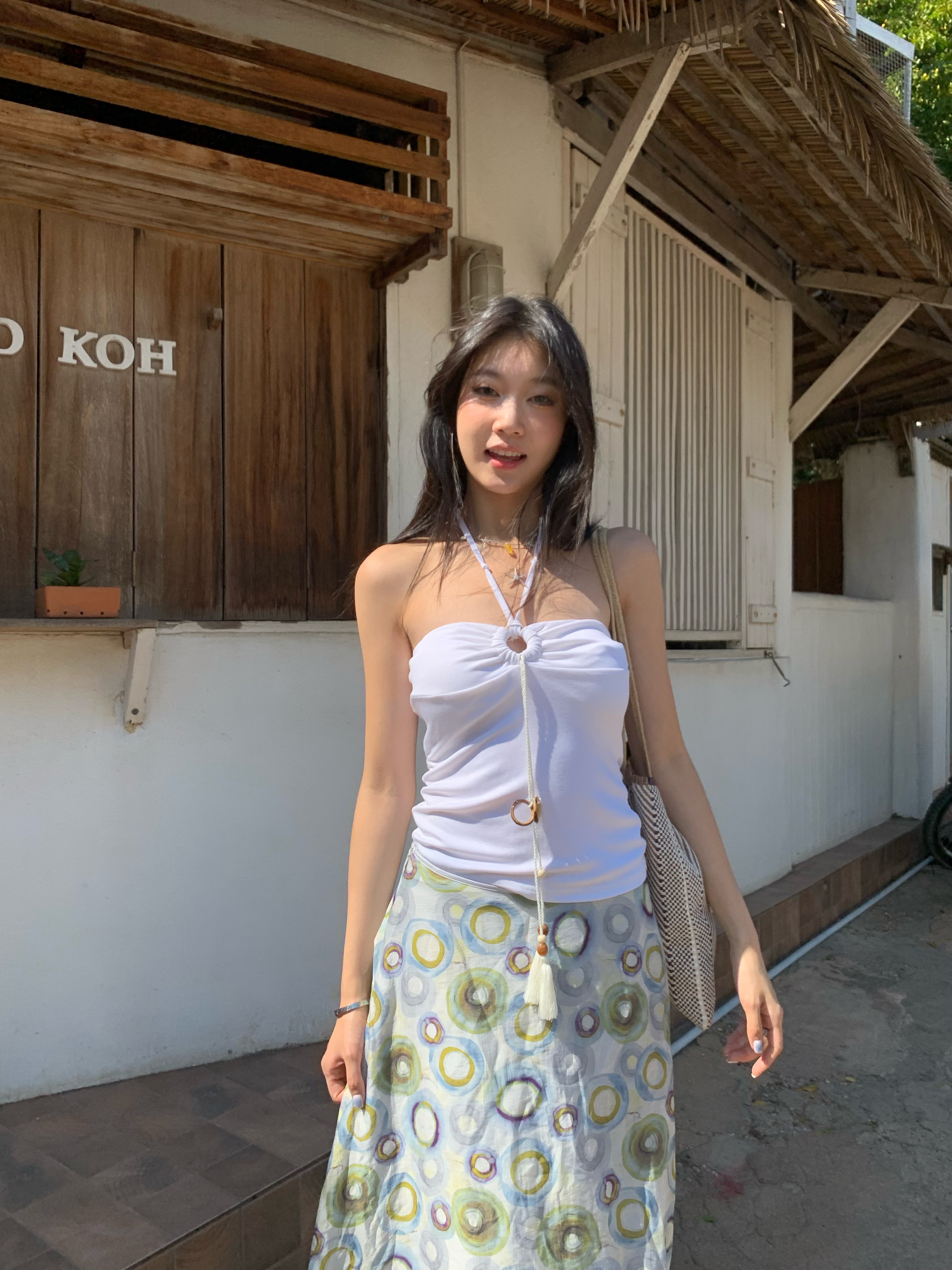 A fitted halter neck top that can be worn as a bra or on its own for a fresh summer look