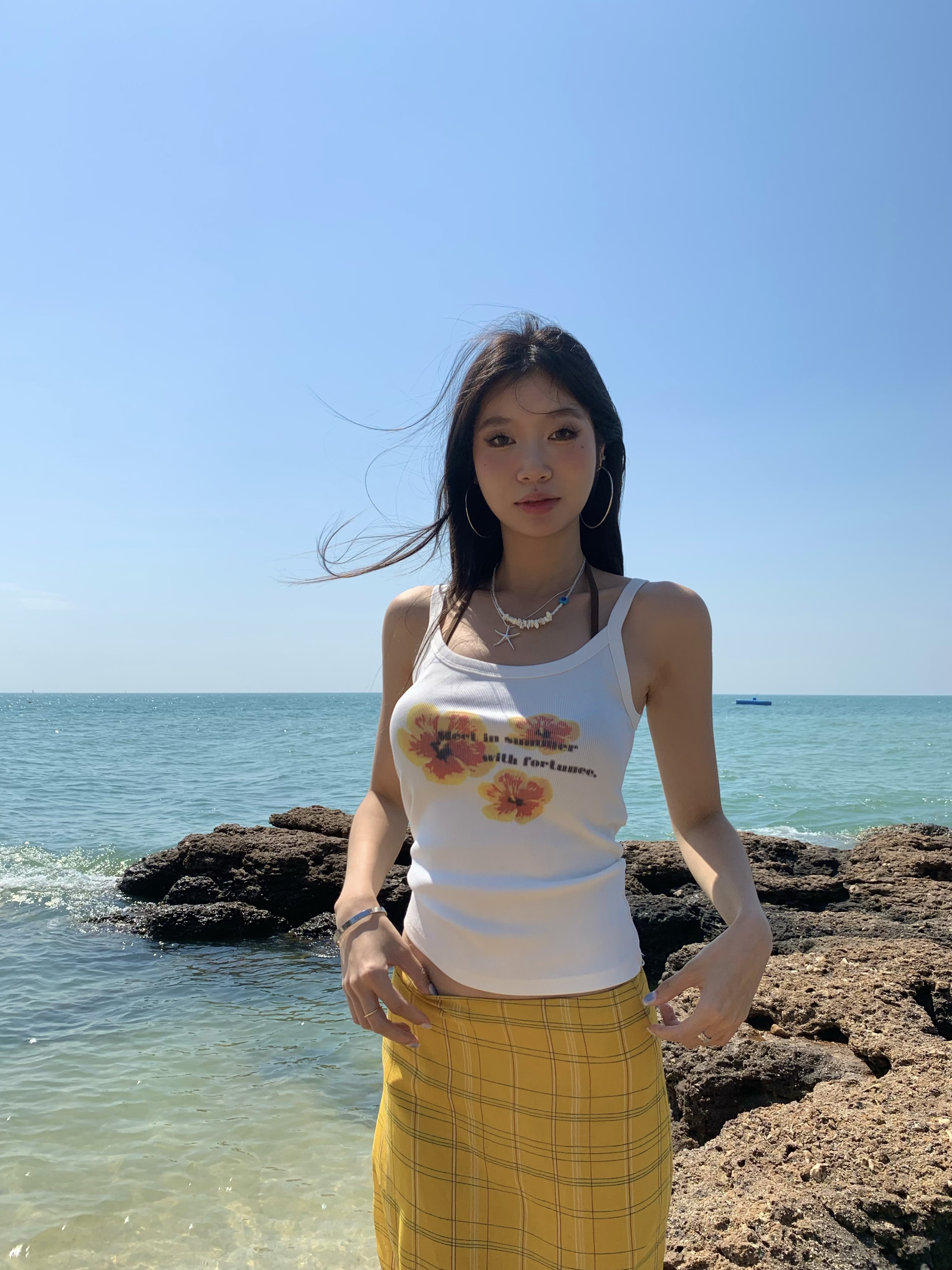 White spaghetti strap top with yellow flowers, bright style, perfect for summer