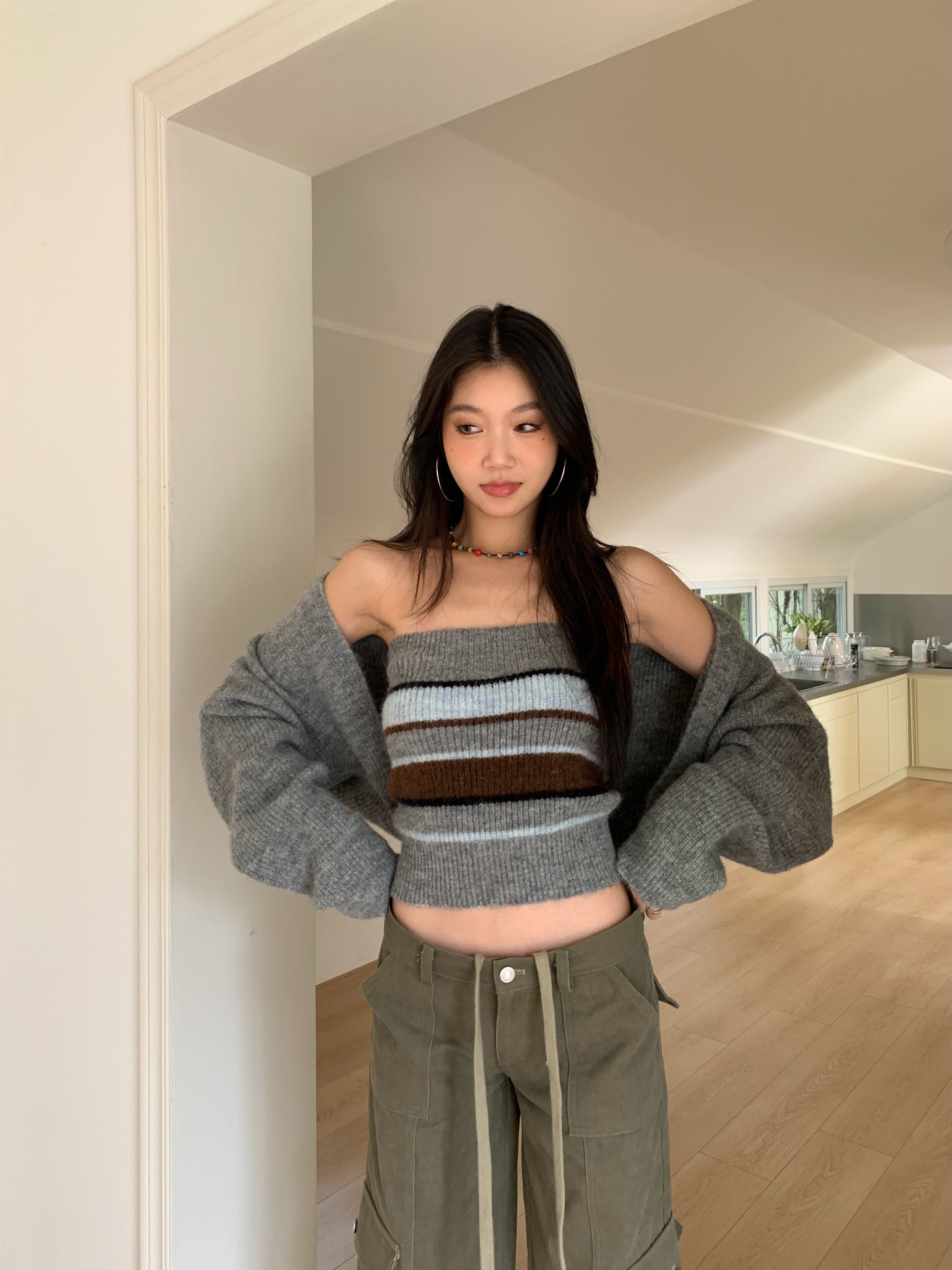 Two-piece set consisting of a two-tone striped knit tube top and a long-sleeve cardigan.