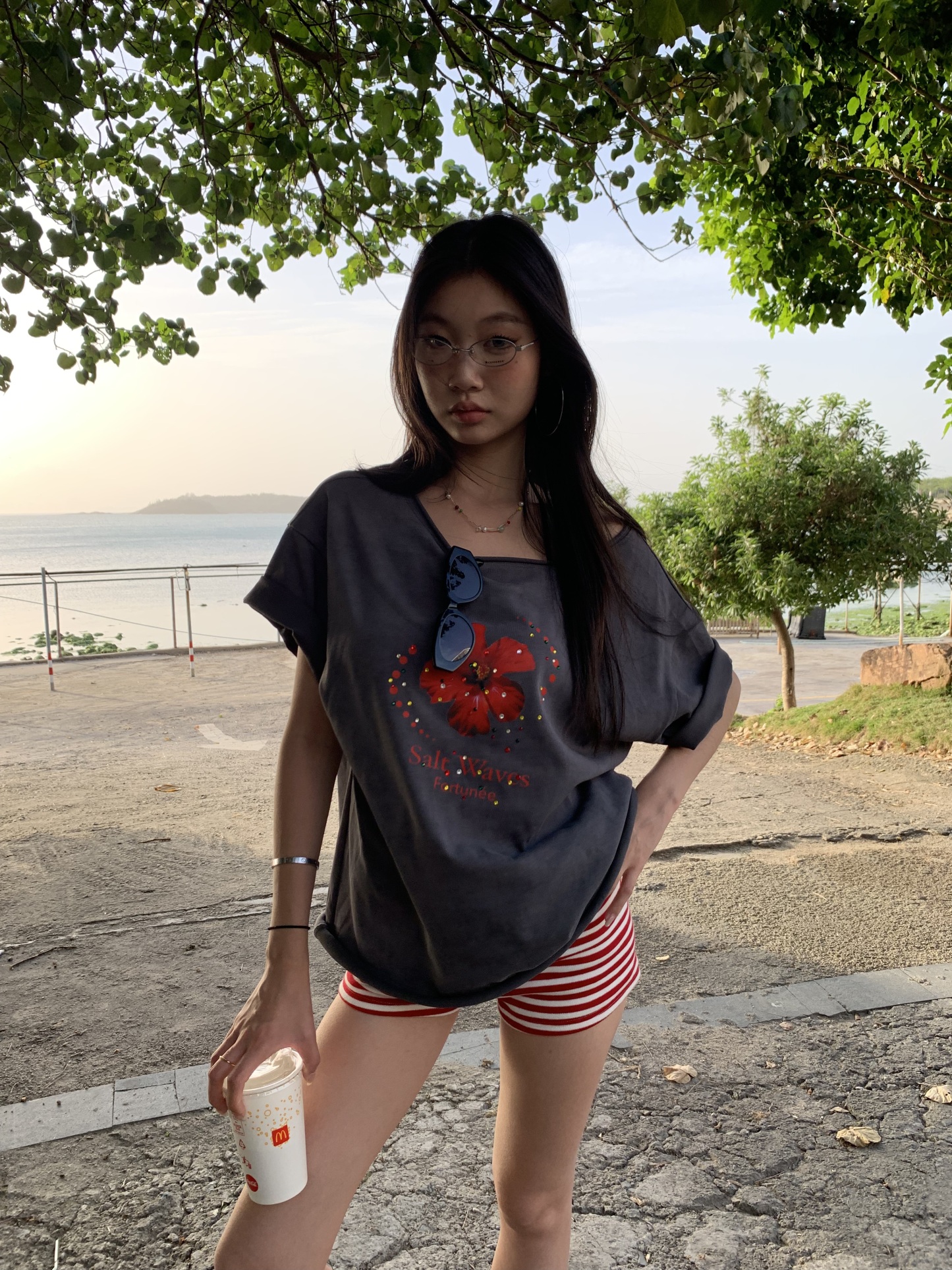 Loose fit hibiscus floral top with one shoulder cutouts