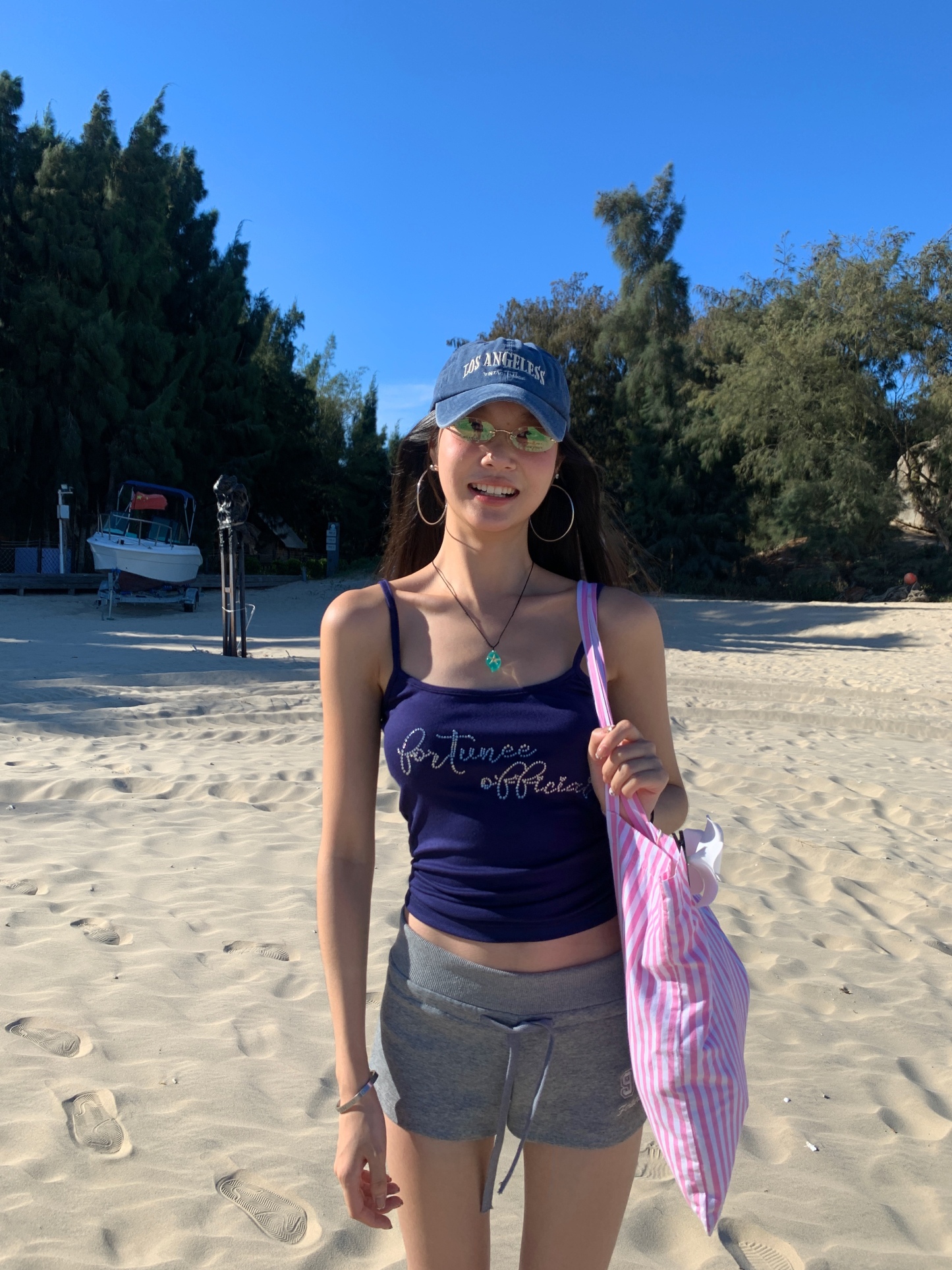 A fitted blue tank top for summer, embellished with a rhinestone letter logo
