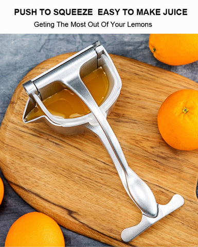 Manual citrus press extracting juice from fruit