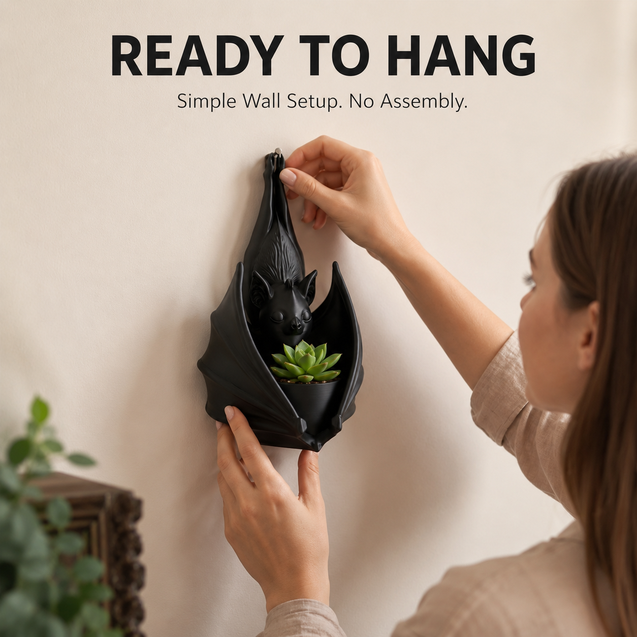 Gothic bat-shaped wall hanging planter with succulent display