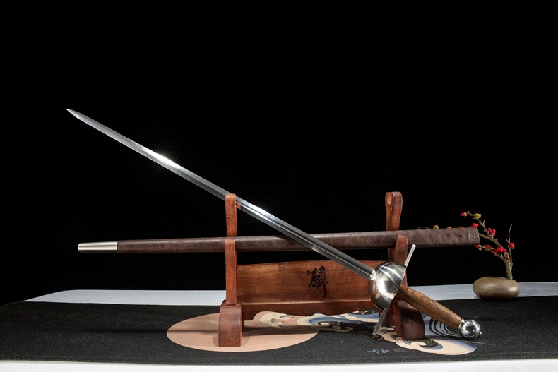 Angled view showing the 65 Manganese Steel rapier positioned in front of its scabbard on a display stand.