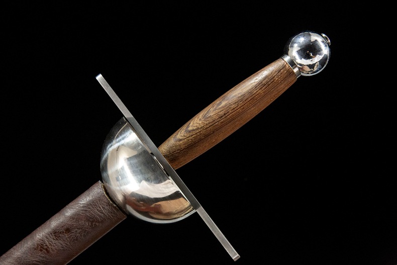 Close-up shot of the wooden grip and metal cup hilt on a 65 Manganese Steel rapier.