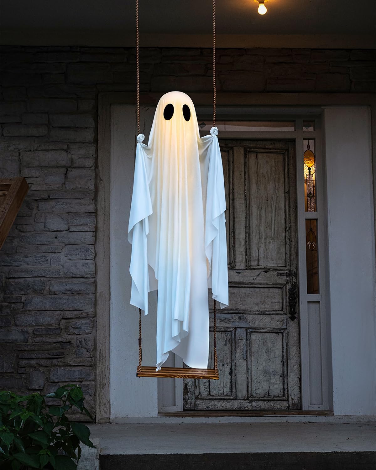 Swinging ghost installed on a covered front porch