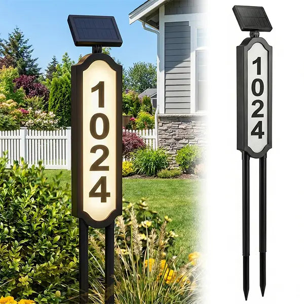 Solar illuminated house number sign in landscaped front yard