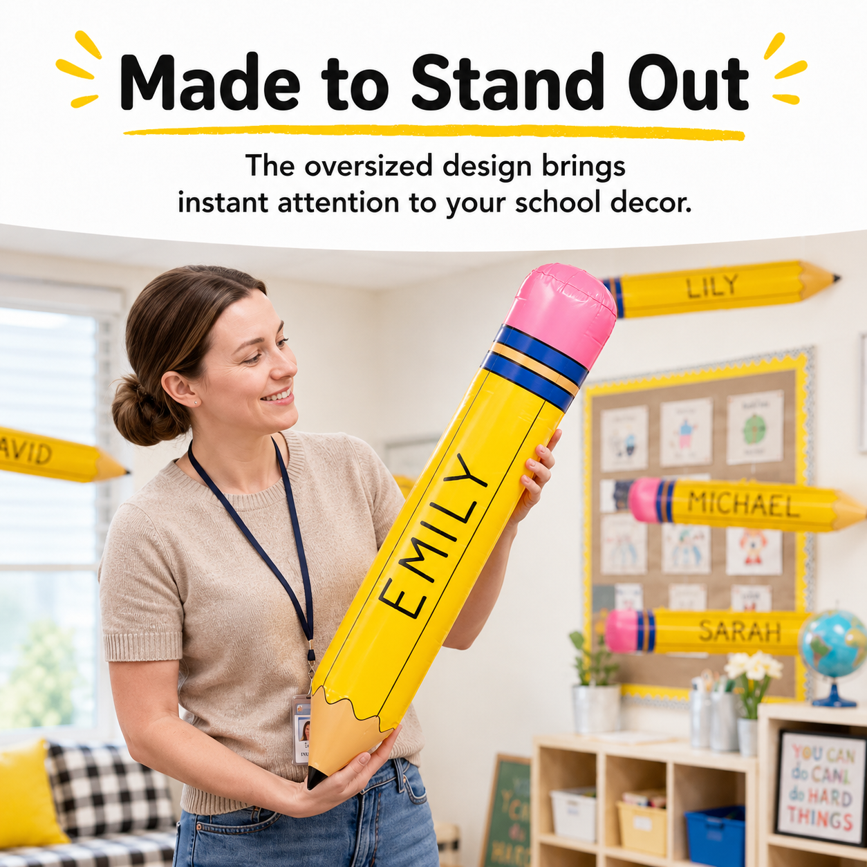 Teacher holding a giant inflatable pencil