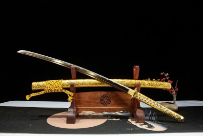 The unsheathed katana and scabbard are artfully displayed at an angle, showing the blade and detail.