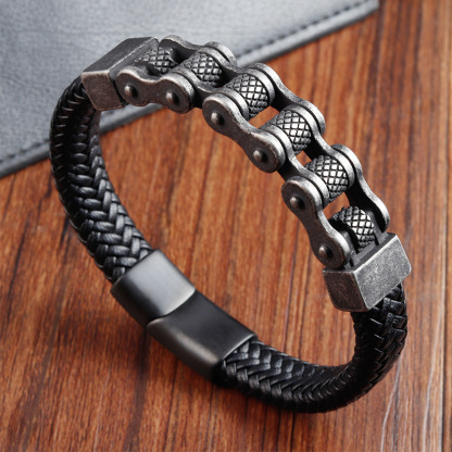 High-angle view of the black braided leather motorcycle bracelet with vintage steel chain elements, showcasing the masculine punk style design.