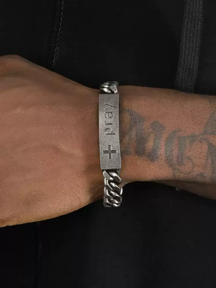 Biker style silver chain bracelet for men by SafeHaven Armor, displayed on a model's wrist next to tattoos.