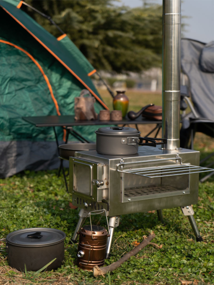 Complete camping wood stove kit including chimney pipes, spark arrestor, ash scraper, and carry bag.