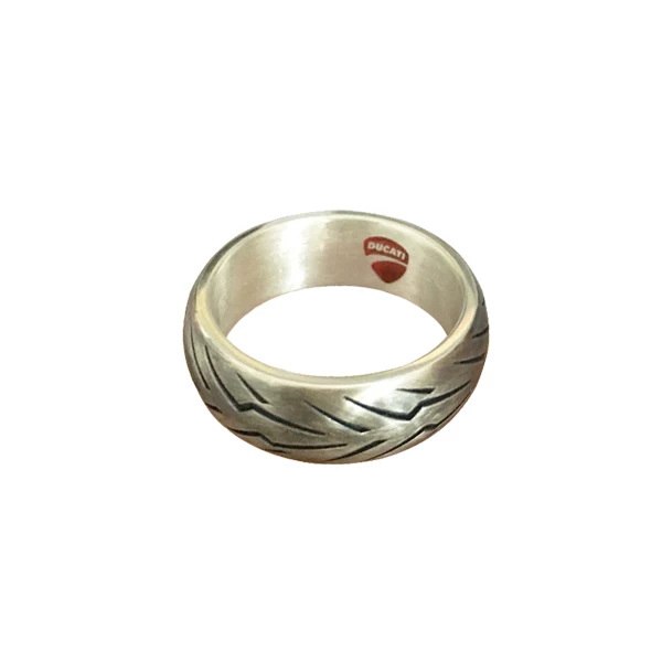 Silver motorcycle tire tread ring featuring a lightning bolt pattern and the red Ducati logo on the inner band.