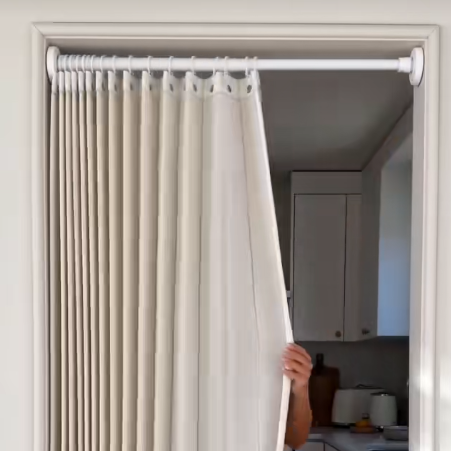 Pleated fabric room divider in a compact home
